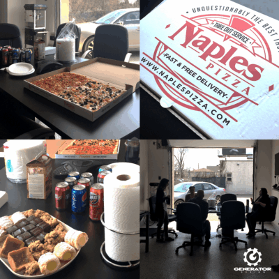 There is food and drinks on the table, along with the generator Team gethering around to eat lunch